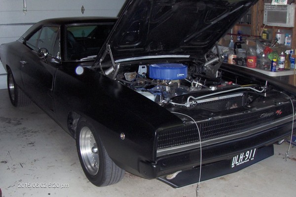 black 1968 dodge charger restomod in home garage