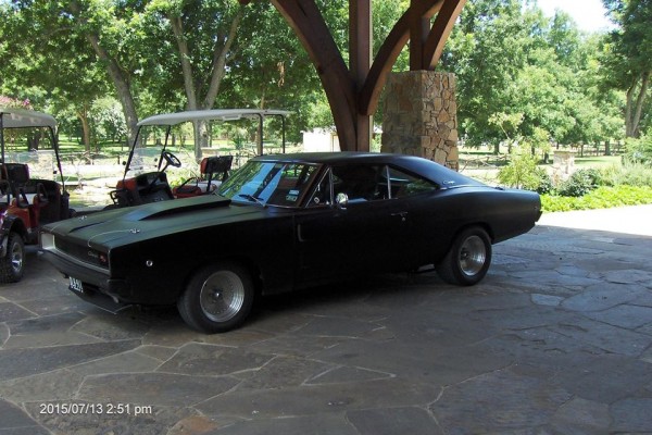 black 1968 dodge charger restomod at golf course