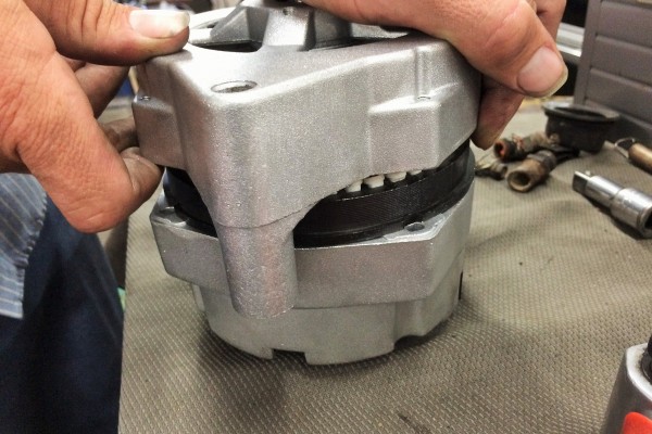 adjusting alternator housing on workbench