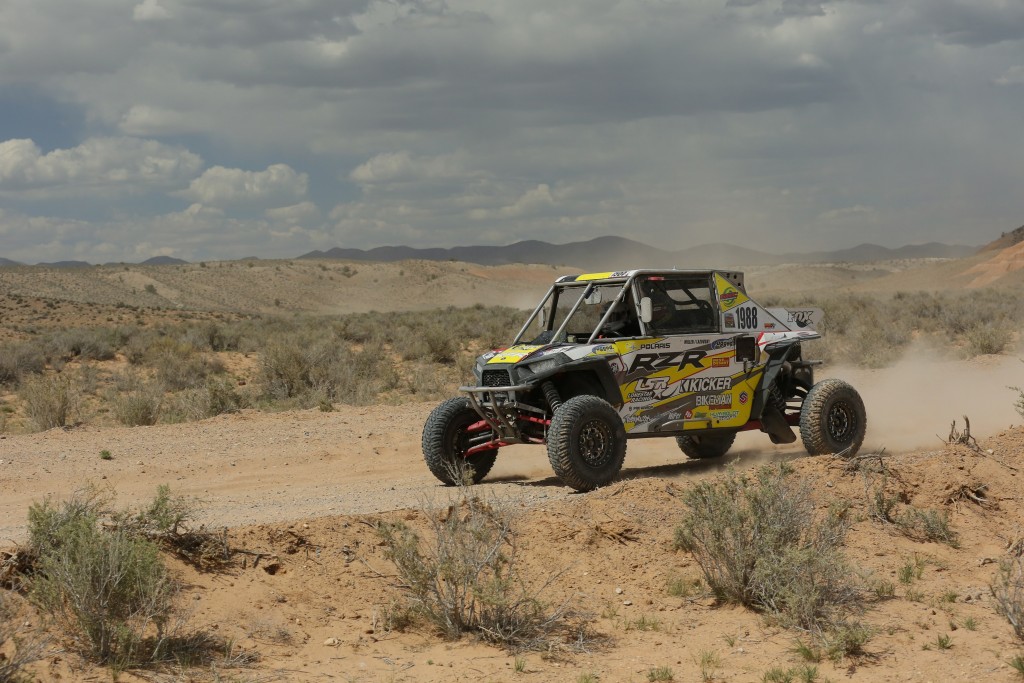 polaris rzr off roader racing down desert trail