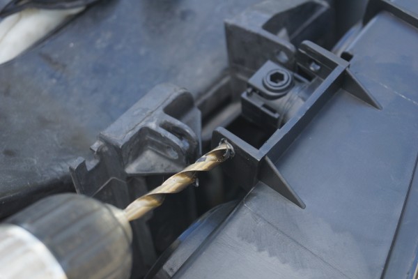 drilling out a hole on a chevy silverado grille bracket