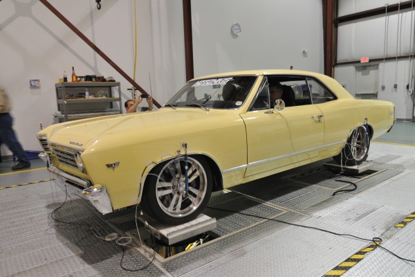 a vintage chevelle on a suspension test apparatus