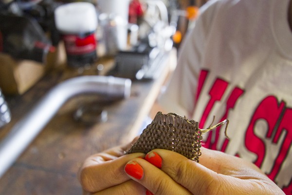 woman holding exhaust pipe wrap