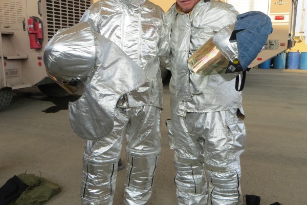 nhra drivers touring fire station in fire gear armor suit