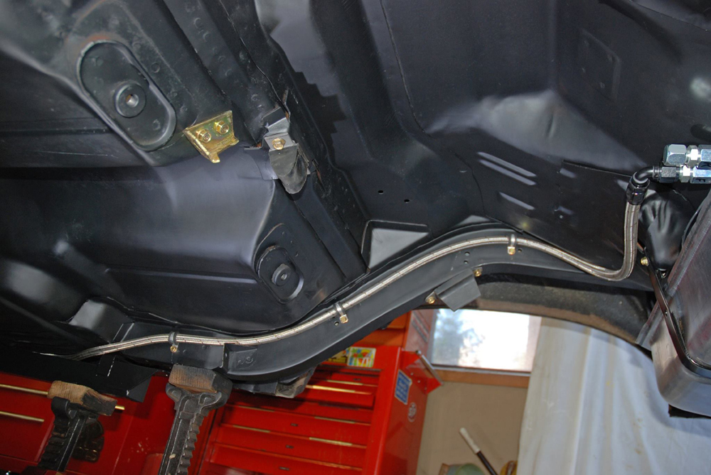 a fuel line routed along an old car frame