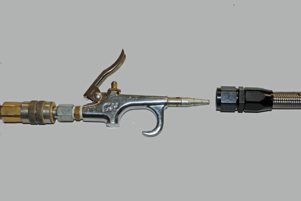 an air gun being inserted into a small section of AN hose