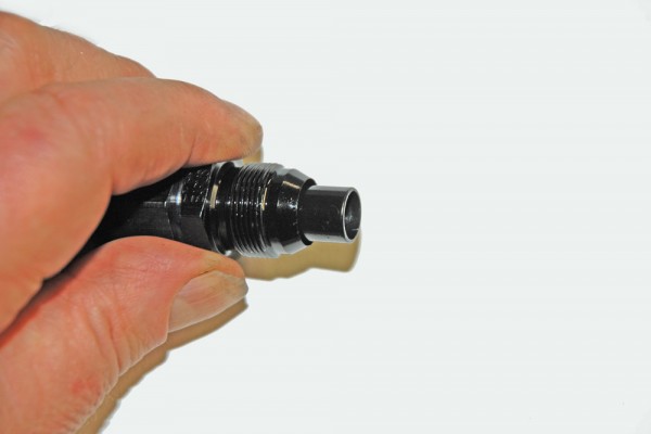 man holding an AN fitting for a fuel hose