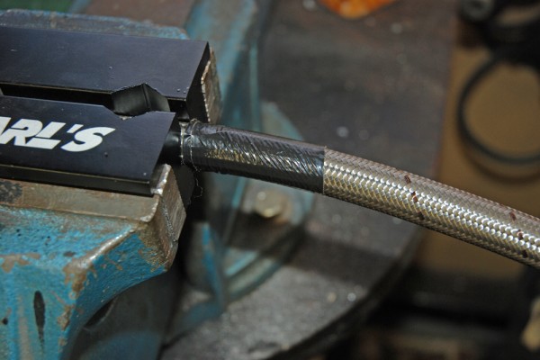 a section of hose wrapped in tape prior to cutting