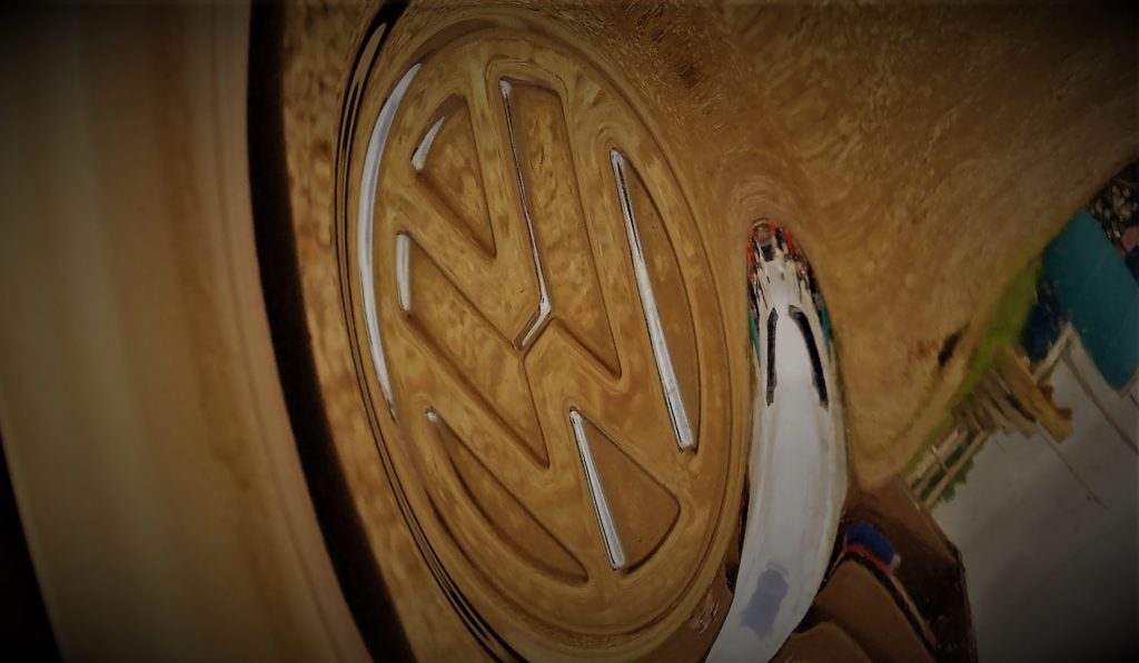 stylized close up of VW logo on a chrome Volkswagen Beetle Hubcap
