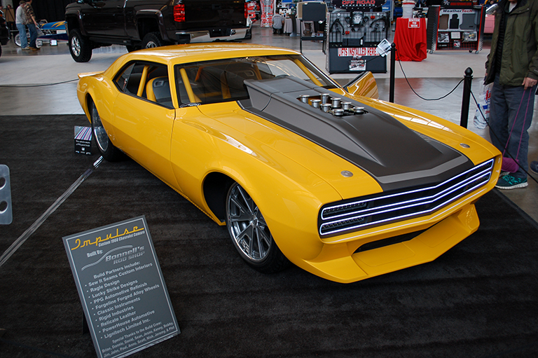 customized yellow chevy camaro rs show car