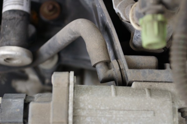 close view of a vacuum hose on an engine