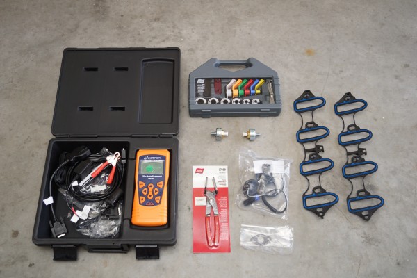 collection of specialty car engine tools on garage floor