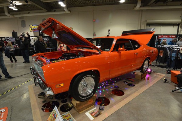orange plymouth duster at indoor car show