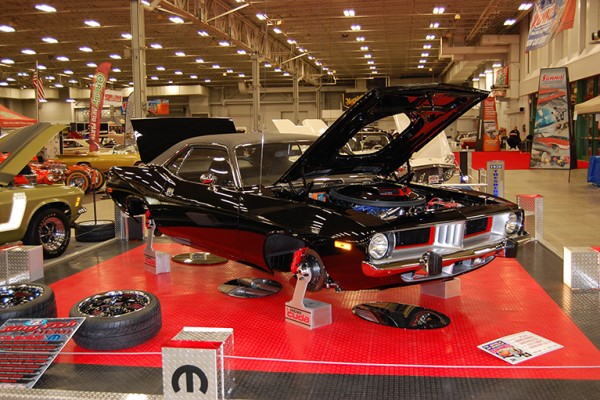 plymouth barracuda with a vinyl top at indoor car show