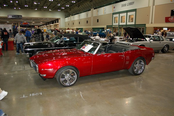 first gen pontiac firebird convertible at indoor car show