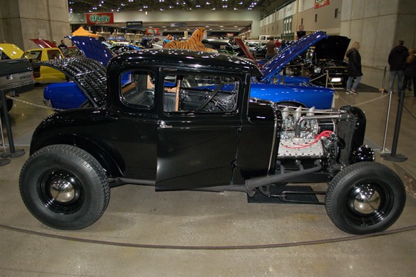 ford five window hotrod coupe at indoor car show