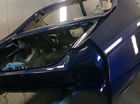blue 1968 chevelle in paint booth during restoration