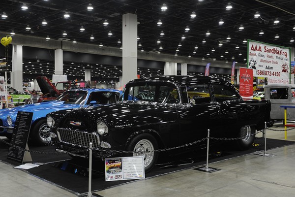 1955 black chevy hot rod coupe at indoor car show