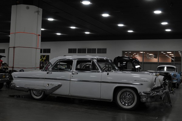 white postwar four door sedan at indoor car show