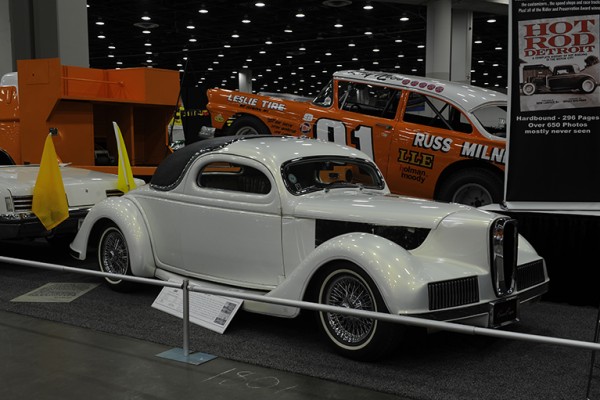 custom hot rod coupe with edsel grille at indoor car show
