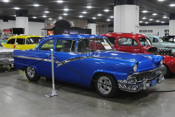 1950s blue ford fairlane custom coupe at indoor car show