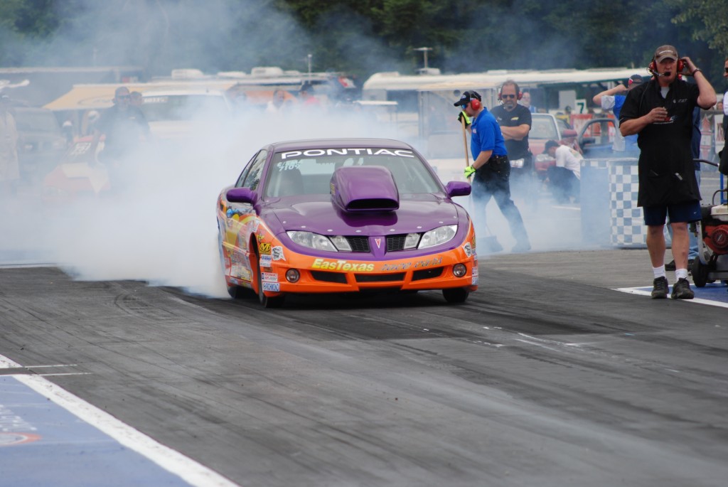 Pontiac drag car launching at strip