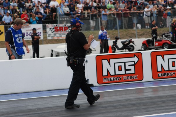 crew chief walking along nhra track