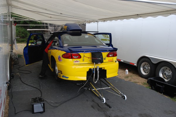 traction bars on a drag race car in pits