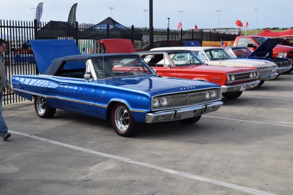 row of classic cars at a car show