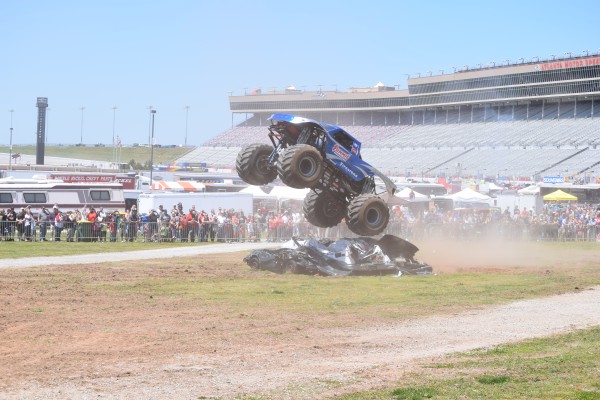 bigfoot monster truck leaping over crushed cars