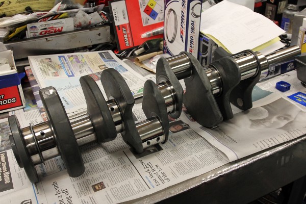 an engine crankshaft sitting on a workbench