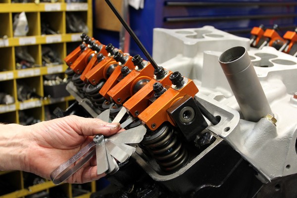 using a feeler gauge for a rocker arm adjustment on an engine cylinder head