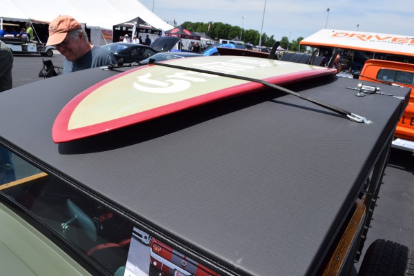 Surf board on the rood of a vintage hot rod