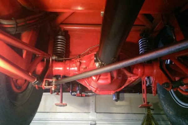 chassis underneath a supercharged chevy nova drag car