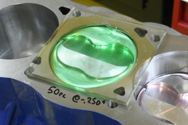using fluid to check combustion chamber volume with pistons