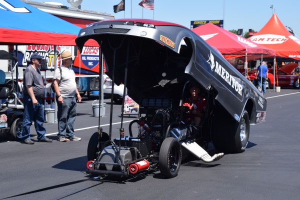 nhra funny car being towed to staging lanes