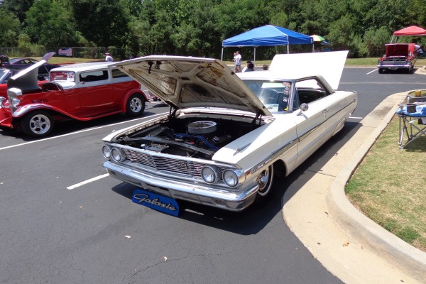 vintage lowered ford galaxie coupe at a car show