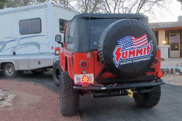 jeep being towed behind an rv camper