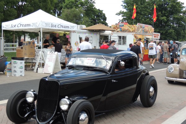 black murdered out ford hotrod in parade