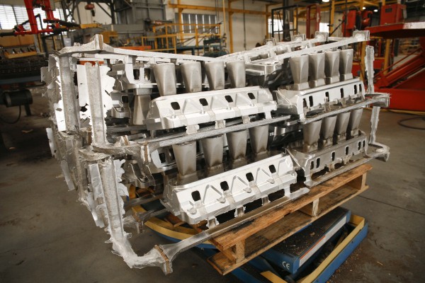 collection of cylinder heads on a pallet in a factory