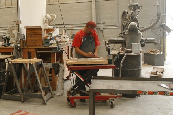 man prepping a mold for sand casting