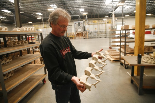 man holding sand casting mold at factory