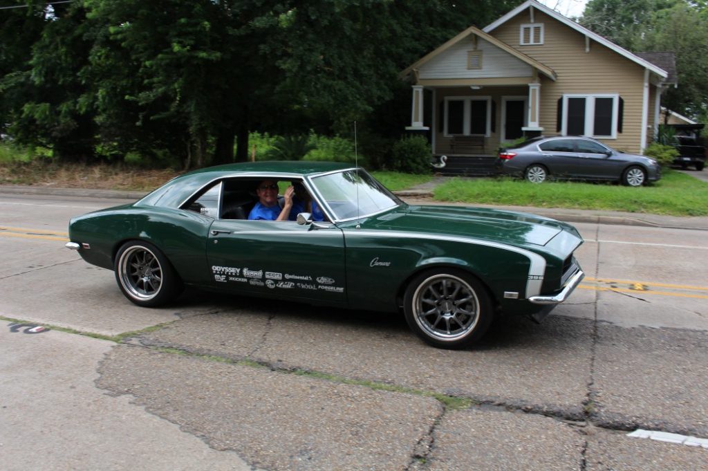 green 1968 chevy camaro on road trip