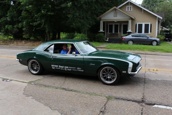 green 1968 chevy camaro on road trip