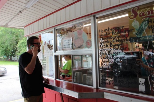 man ordering food at roadside stand