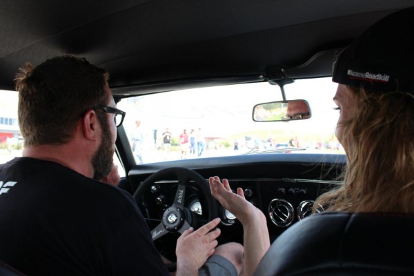 rutledge wood driving a vintage camaro