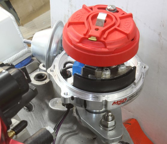 This is an adjustable rotor fitted to an MSD distributor. Note that we’ve positioned the rotor just before the black line on the distributor body. When the mechanical advance moves the rotor (roughly 21 degrees or 15 initial + 21 mechanical = 36 degrees BTDC), it will swing from before the terminal to after, which will be as close as we can get throughout the entire advance curve.