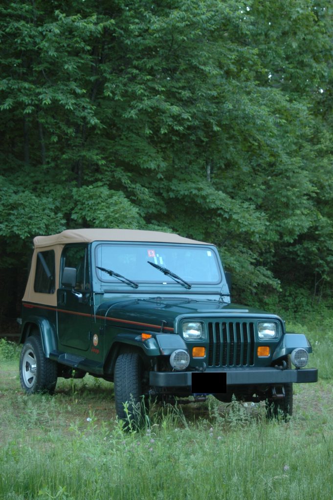 jeep yj wrangler parked in a field