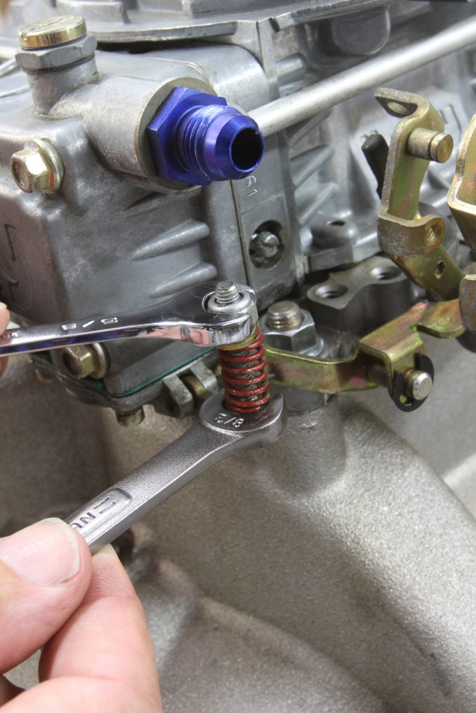 adjusting a screw on a carburetor