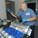 man torqueing down camshaft bearing caps on ford modular ohc engine thumbnail